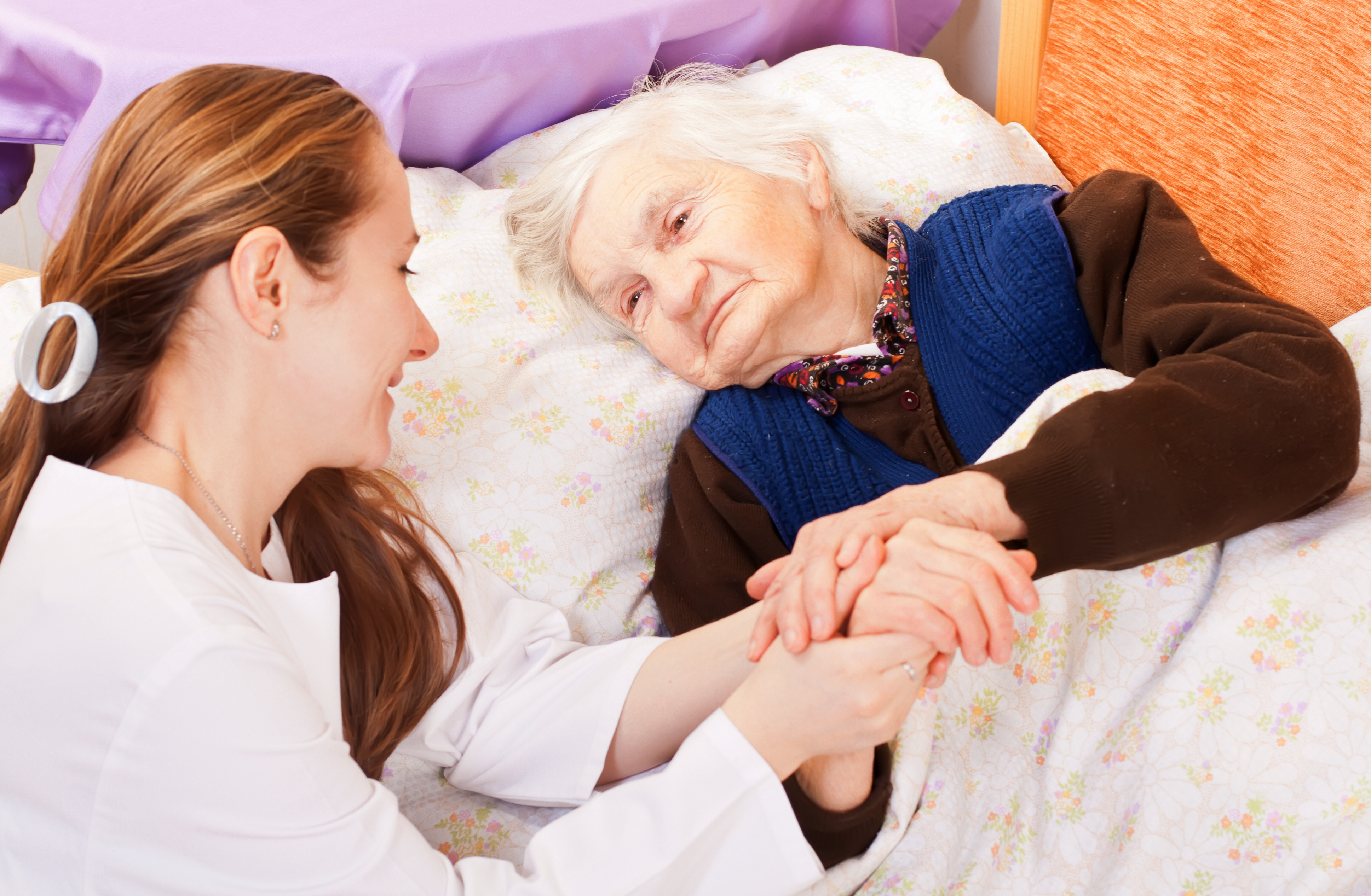 Young Female Holds The Old Woman's Hands